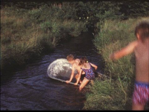 Vintage 8mm film: Children in bathtub on pond, 1960s