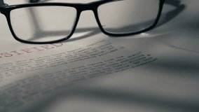 Classified Top secret document with pair of glasses close up zoom dolly selective focus - Powered by Shutterstock - Get 15% off with code: PIKWIZARD15