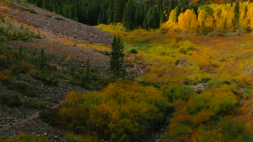 Maroon Bells Pyramid Peak Aspen Snowmass Colorado wilderness Incredible stunning cinematic aerial drone fall autumn colors snow covered Rocky Mountains peaks morning pan up slow reveal forward motion