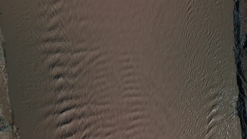 Top down aerial above muddy Virgin River in Mesquite Nevada desert