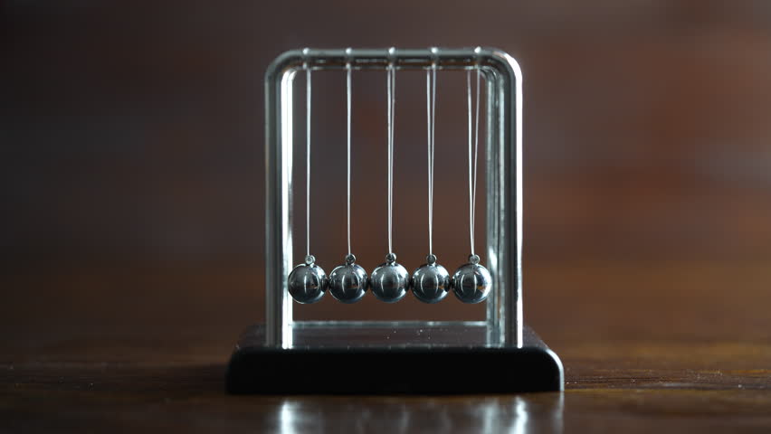 Metal Newton cradle placed on wooden background as representation of momentum concept, cradle balance steel balls, school teaching supplies, desk toy, gifts home decoration Royalty-Free Stock Footage #3443761679