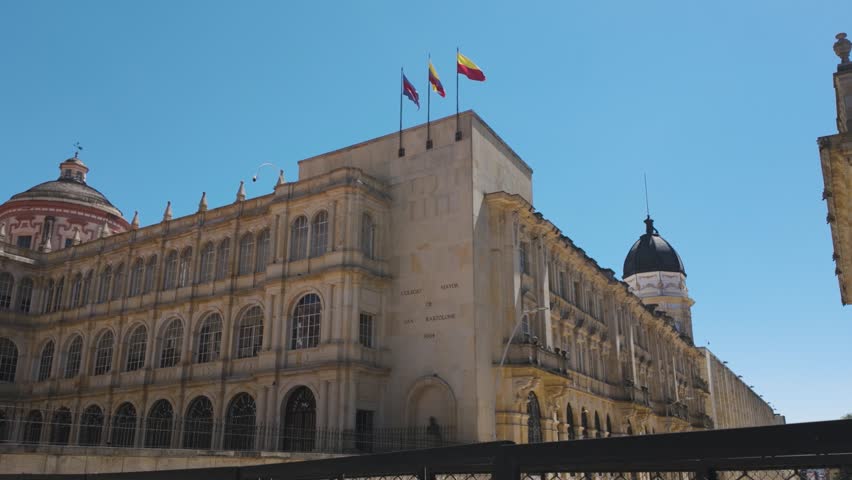 Main Facade Of National College of St. Bartholomew - the oldest Colombian school. Pan Left Shot On Sunny Clear Day