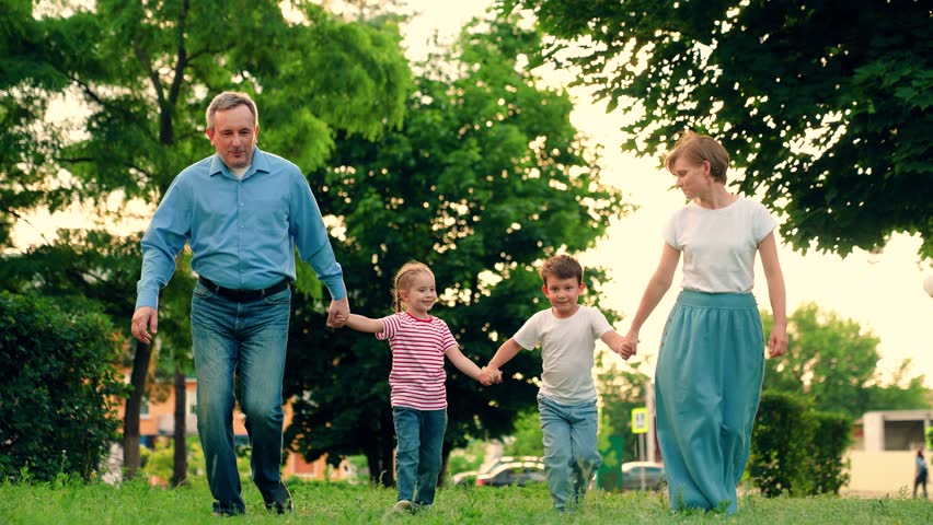 Children and parents run together on green grass. Family game, father mother daughter son fun running in park. Happy family team. Children dream, mom dad children in nature. Weekend play, holiday kids Royalty-Free Stock Footage #3443931675