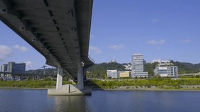 A 4k slow motion video from a boat as it passes under Tilikum Crossing Bridge which passes over the Willamette River in Portland Oregon.