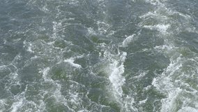 A 4k slow motion video of the wake water trace from a large ship.