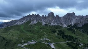 The Dolomites mountains with cloudy weather in summer season, Italy. Aerial drone view