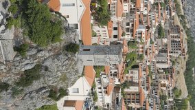 Vertical video. Arachova, Greece. Arachova is a small town in Greece, in the community of Distomon-Arachova-Andikira. Sunny weather with clouds. Summer, Aerial View, Point of interest