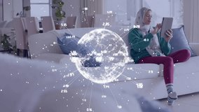 Animation of globe with network of connections over biracial woman in hijab using tablet. Global data processing, computing and digital interface concept digitally generated video. - Powered by Shutterstock - Get 15% off with code: PIKWIZARD15