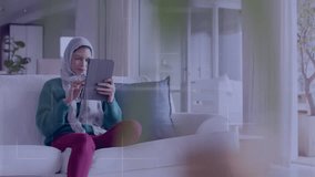 Animation of globe with network of connections over biracial woman in hijab using tablet. Global data processing, computing and digital interface concept digitally generated video. - Powered by Shutterstock - Get 15% off with code: PIKWIZARD15