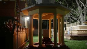 Buddhist temple night, illuminated evening meditation. Worshipers incense, pray. Sacred tree shrine, peace envelops site. Serene ambiance invites reflection, spiritual practice moonlight. - Powered by Shutterstock - Get 15% off with code: PIKWIZARD15