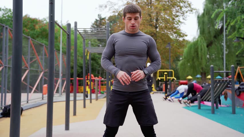 a man is standing in front of a playground in a park