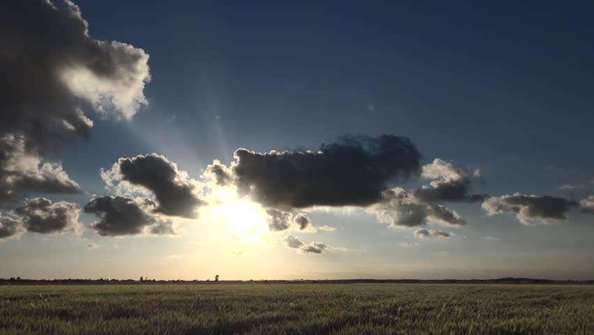 Time lapse video of sunset sun in partly cloudy sky on flat plain. Royalty-Free Stock Footage #3444162491