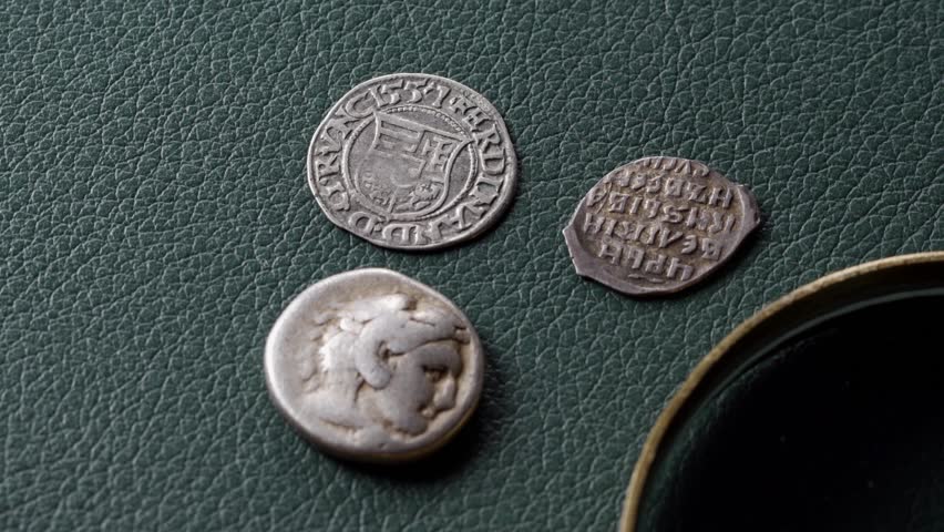 Antique Roman coin and medieval Hungarian and Russian silver coins rotate, numismatics and the history of finance Royalty-Free Stock Footage #3444246017
