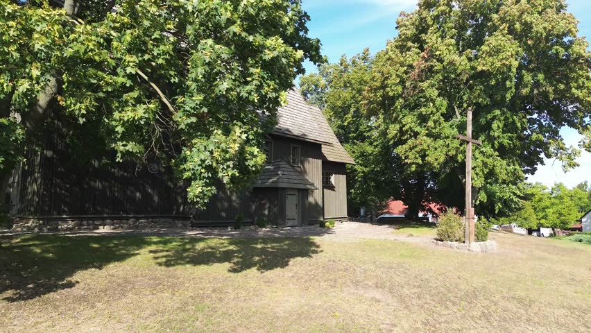 fly toward ancient medieval wooden church in poland cross christian