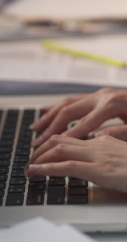 Vertical Screen: Close Up Footage of a Project Manager's Hands Focused on a Laptop Computer Keyboard. Managing, Organizing and Processing Critical Documents and Communication for Remote Workflow Royalty-Free Stock Footage #3444297587