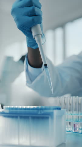 Vertical Video. Medical Development Laboratory: Scientist Wearing Face Mask Uses Micro Pipette Dropper to Mix Petri Dish Sample. Medicine, Biotechnology Research in Advanced Pharma Lab