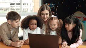 Caucasian teacher looking at african learner work or presentation. Group of diverse student looking at presentation while learning about coding and programing data at STEM technology class. Erudition. - Powered by Shutterstock - Get 15% off with code: PIKWIZARD15