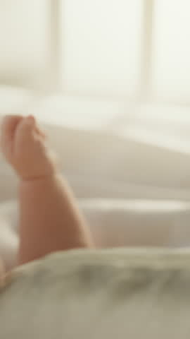 Vertical Format Video of a Close Up with Newborn Baby Hand Holding Mother's Finger while Lying in Child's Crib at Home. Concept of Childhood, New Llife, Parenthood. Royalty-Free Stock Footage #3444365685