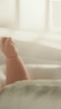 Vertical Format Video of a Close Up with Newborn Baby Hand Holding Mother's Finger while Lying in Child's Crib at Home. Concept of Childhood, New Llife, Parenthood.