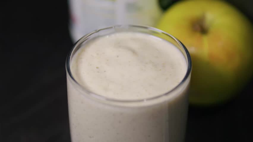 Thick greek yoghurt oatmeal and apple smoothie in glass. Healthy eating concept.