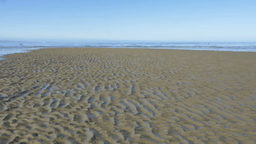 Time lapse of incoming tide, sea water level rising, taking over the beach, waves covering the golden sand, rib pattern stretching out, South Island coast, New Zealand | Shutterstock HD Video #34444549