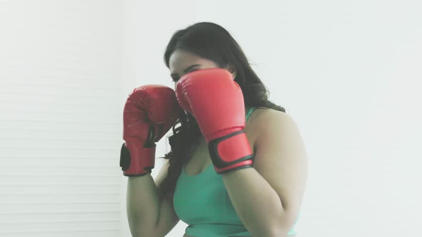 Plump Asian woman practices boxing Royalty-Free Stock Footage #3444460611