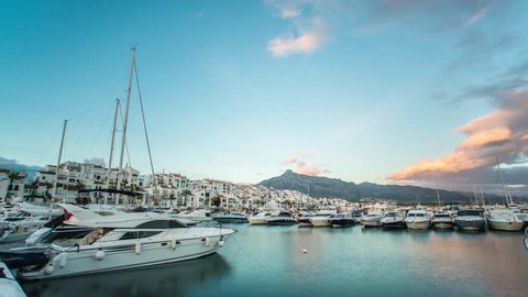 Day to night timelapse of Leisure port in Marbella at sunset. Beautiful landscape of the harbor of puerto banus in Malaga coast