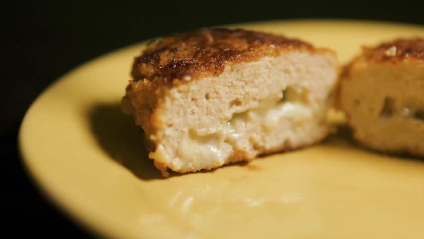 Chicken Cordon Bleu cutlet with cheese inside cut in half. Close up. Royalty-Free Stock Footage #3444508175