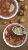 Soup scoop on a spoon. Snow Fungus sweet soup from Chinese cuisine. Vertical video.