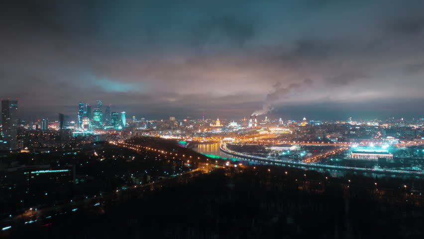 An amazingly beautiful hyperlapse of Moscow's Sparrow Hills on a foggy night with glittering traffic lights, business center buildings in the background, and the Moskva River. Royalty-Free Stock Footage #3444559181