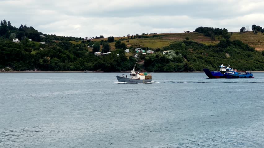 Fishing boats cruising the Seascape in the Dalcahue Canal, Chile