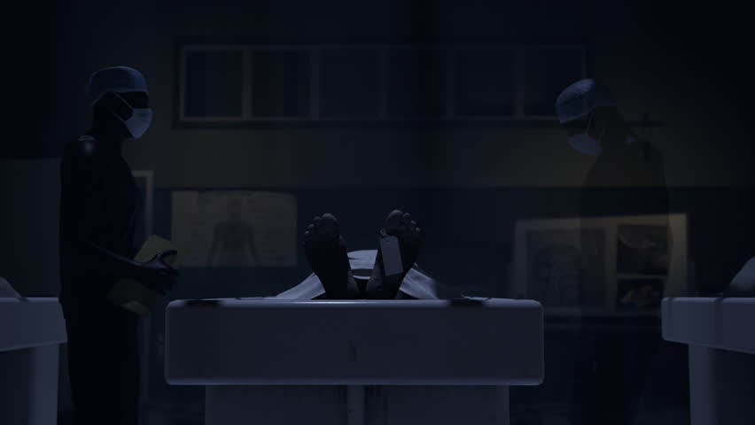 Two doctors standing in fron of a corpse in the morgue and ready to execute an autopsy