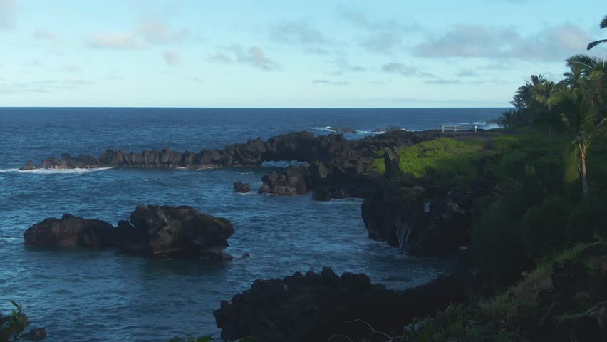 Slow pan right shot of Waianapanapa State Park, coastal scene, Hawaii
