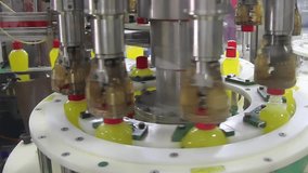 Close up of liquid detergent on automated production line. Machinery for bottling, filling plastic bottles with detergent and twisting the caps. Moving on production line bottling and packing - Powered by Shutterstock - Get 15% off with code: PIKWIZARD15