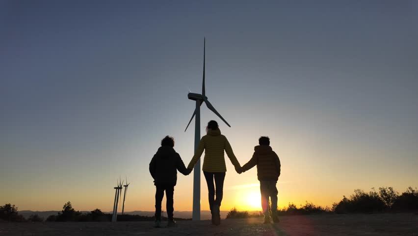 A heartwarming portrayal of a single mother guiding her two sons towards a sustainable future. Exploring green technology, wind turbines, and environmental conservation.	 Royalty-Free Stock Footage #3444737135