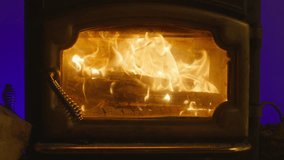 Winter mood in comfortable home concept. Fire blaze burning in cozy mountain cabin. Cozy house chimney fire place still shot. Hot fierce fire flames blazing in black iron fireplace during winter time - Powered by Shutterstock - Get 15% off with code: PIKWIZARD15