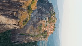 Vertical video. Meteora, Kalabaka, Greece. Monastery of the Transfiguration of the Saviour. Meteora - rocks, up to 600 meters high. There are 6 active Greek Orthodox monasteries listed on the UNESCO