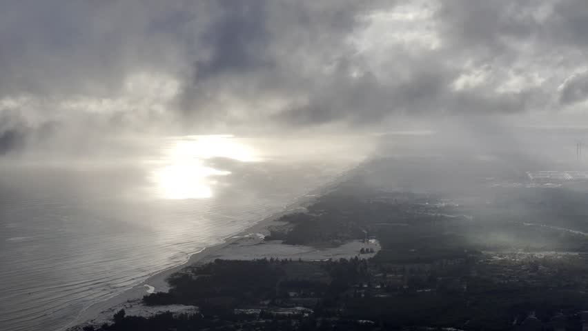 Brilliant sunrise by the sea with fog and wind power