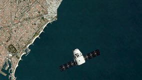 4K Video Of a Space Satellite Orbiting Over Earth Surface Near Barcelona. Global Satellite Internet Concept Made with NASA Imagery.