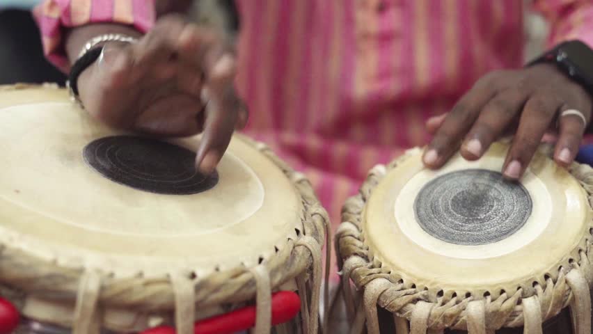 Close-up of hands of an Indian man playing a paired tabla drum. A pair of hand on a drum.  Royalty-Free Stock Footage #3445001557