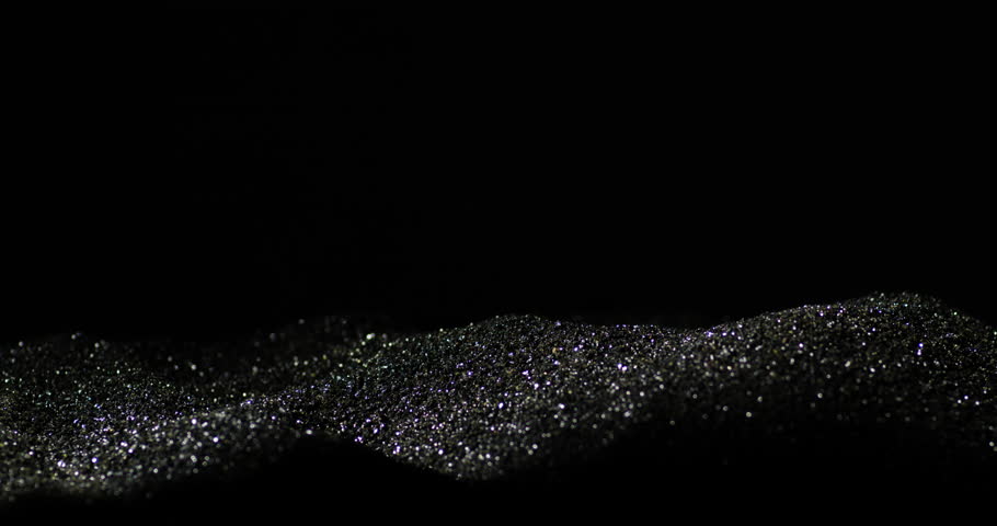 Bullets Falling Over Smokeless Gunpowder With Black Backdrop. Slow Motion Shot