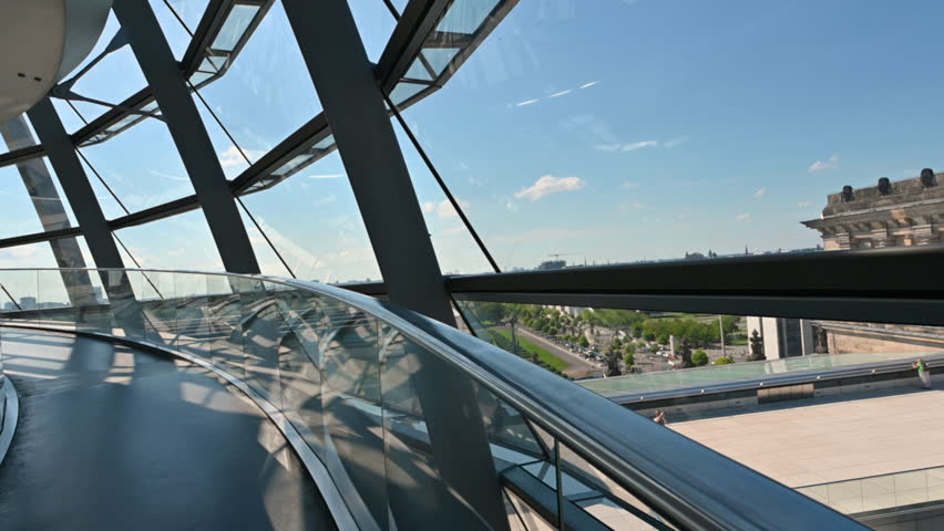 Berlin, Germany, August 15, 2023. Immersive POV footage walking on the glass and metal dome located on the roof of the Reichstag building. Beautiful summer day with bright light.