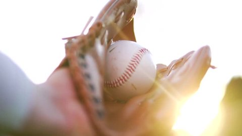 Cinematic Baseball Catch Through Sunshine In Fielder's Glove, Slow Motion. Outdoor Sports And Exercise.