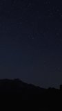 Timelapse of moving star trails in night sky. vertical video for social media. 