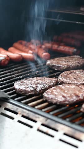 Hot dogs and hamburgers are char-grilled on a backyard bbq.  Royalty-Free Stock Footage #3445170561