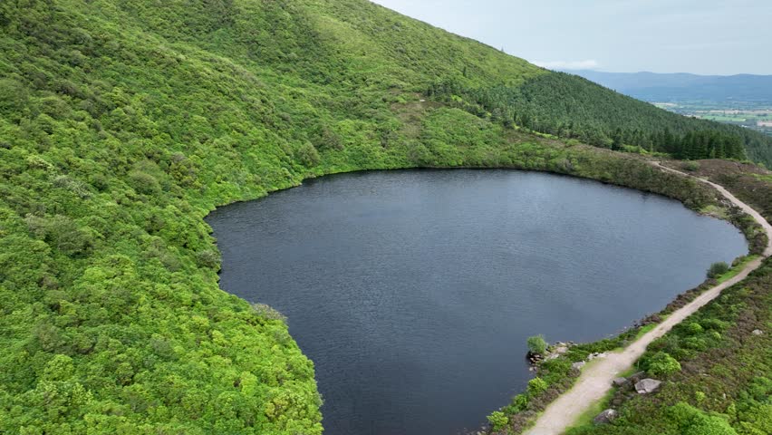Mountain lake in the middle of green mountains in 4k
