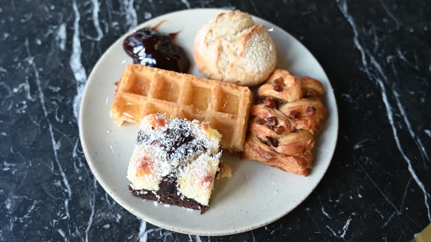 Sweet breakfast in Belgium. Waffle, bread, jam, honey and cakes. 
