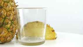 Pours pineapple juice into a glass - Powered by Shutterstock - Get 15% off with code: PIKWIZARD15