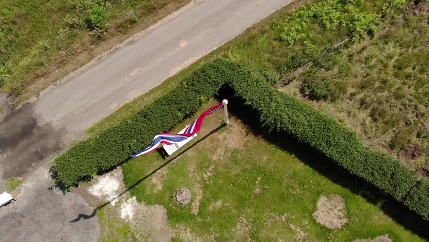 Drone moving around a flag pole