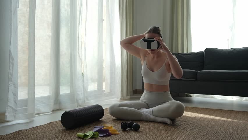 VR sport,Workout home vr,Fitness vr home,VR fit.Girl doing fitness in VR glasses home ,virtual reality exercise, immersive workout,VR sports,virtual gym,immersive spaces,futuristic environment Royalty-Free Stock Footage #3445240673